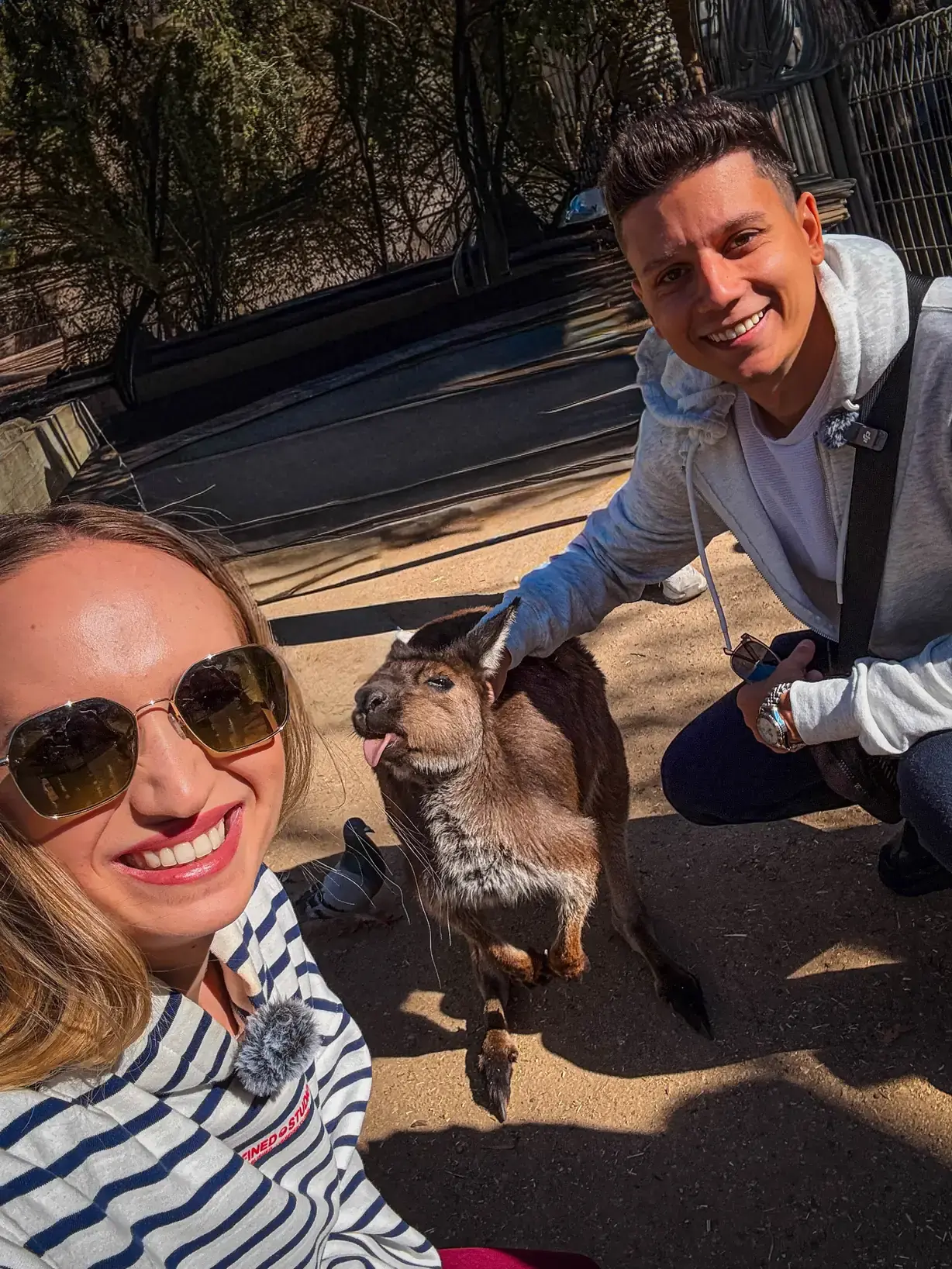 Andrei and Cristina taking a selfie with a kangaroo in Australia